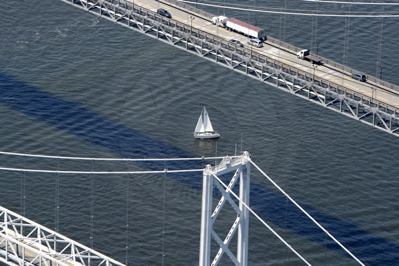 A sailboat on the Chesapeake Bay under the Bay Bridge